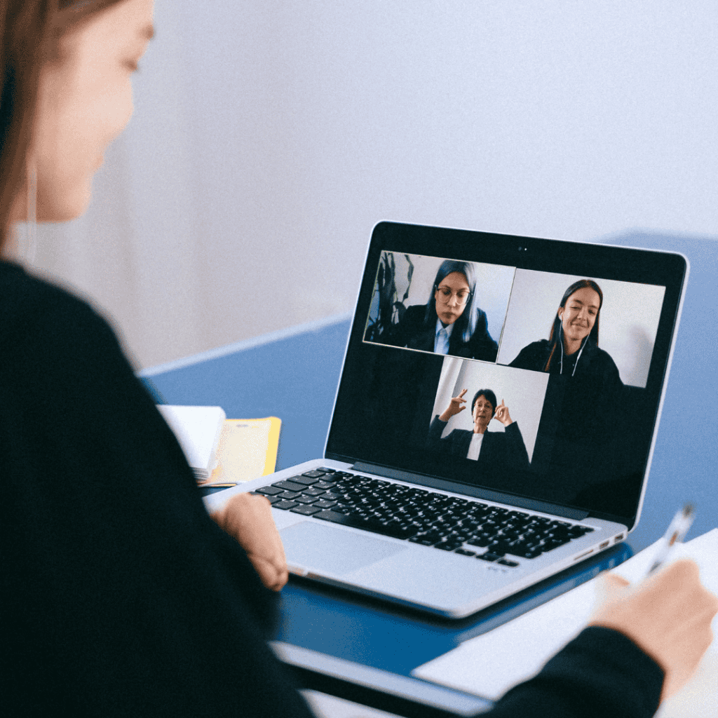 Remote team engaging in virtual team building activity via video call.