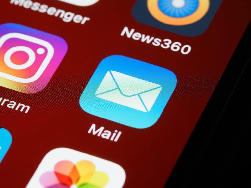 Email app icon on smartphone screen for digital marketing.