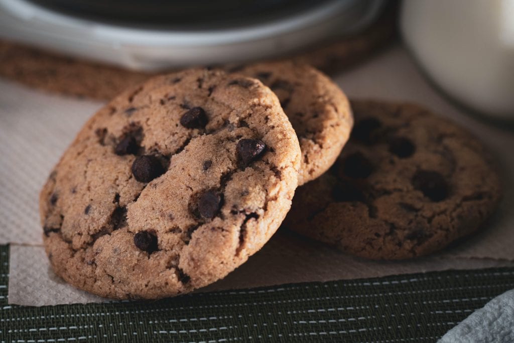 Freshly baked chocolate chip cookies on a plate.