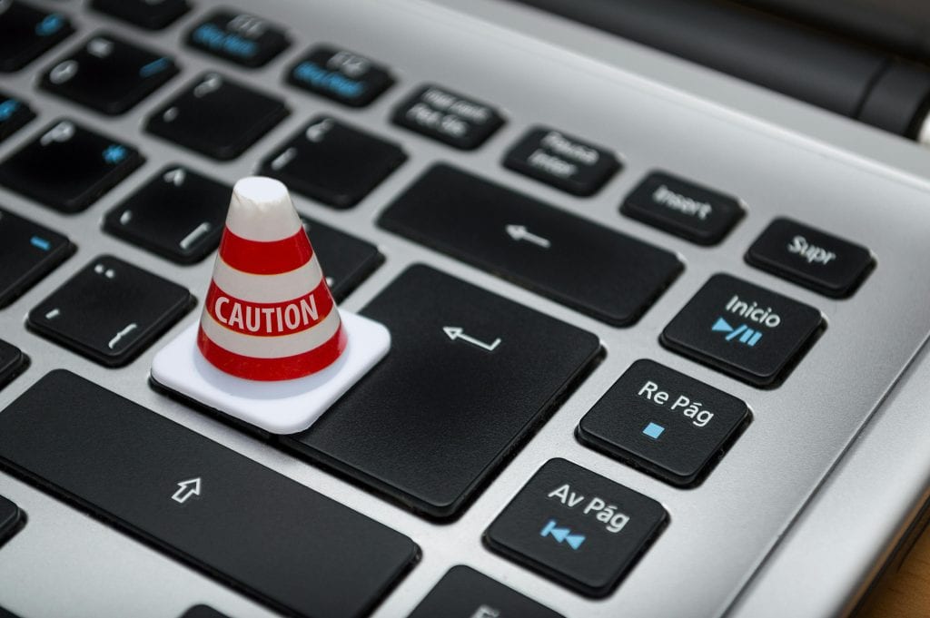 Caution cone on a laptop keyboard highlighting data consent issues in the EEA.